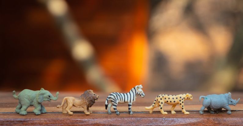 Play - Plastic Animal Toys on Wooden Surface