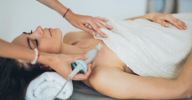 Skincare Technology - A Woman Lying Down with Towel on Her Body